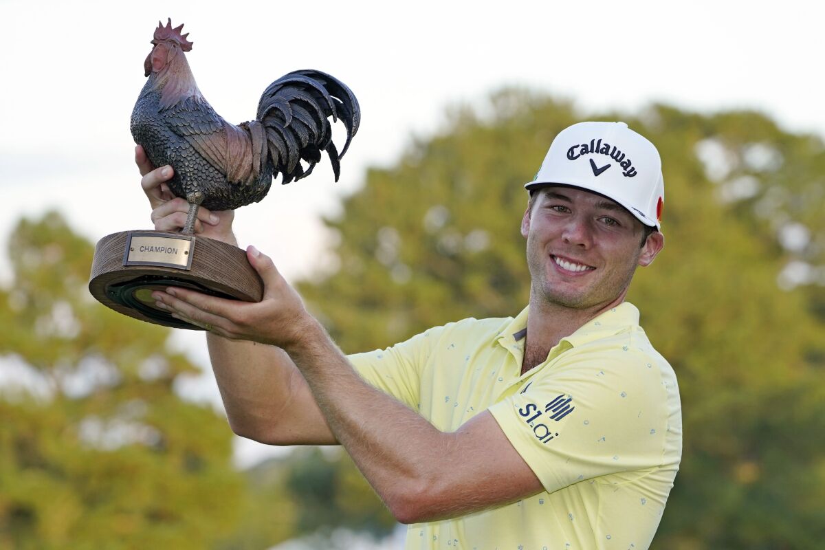 Sam Burns holds the champion's trophy after winning the Sanderson Farms Championship golf tournament in Jackson, Miss., Sunday, Oct. 3, 2021. (AP Photo/Rogelio V. Solis)
