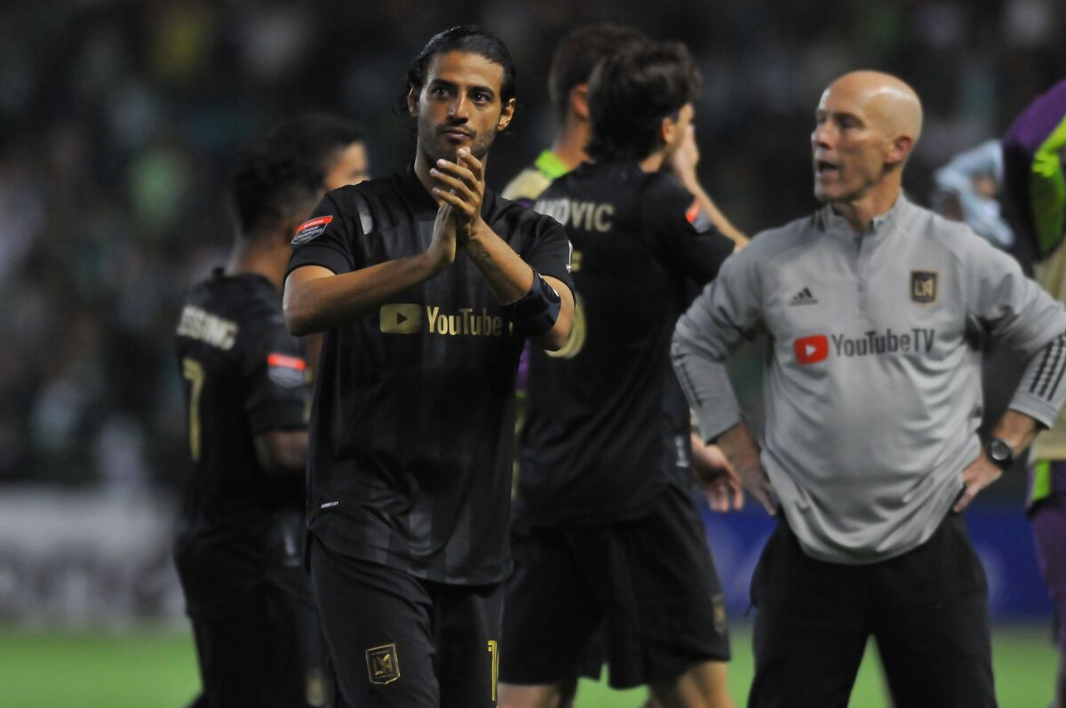 US LAFC's Carlos Vela (L) applauds the crowd at the end of the first leg quarterfinal football match.