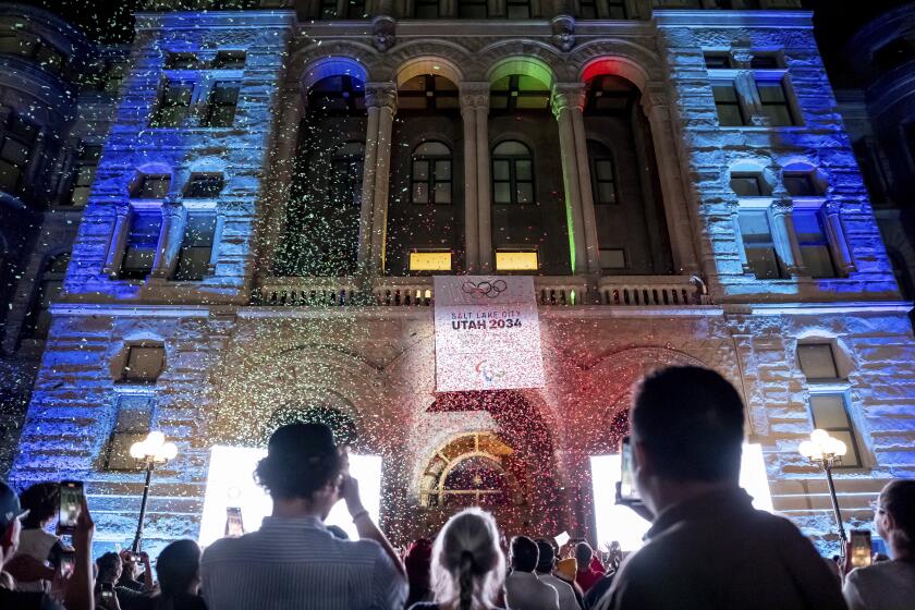 Confetti falls as the logo for the 2034 Winter Olympics is unveiled on the Salt Lake City and County Building after Salt Lake City was announced as the host city, Wednesday, July 24, 2024, in Salt Lake City, Utah. (AP Photo/Spenser Heaps)