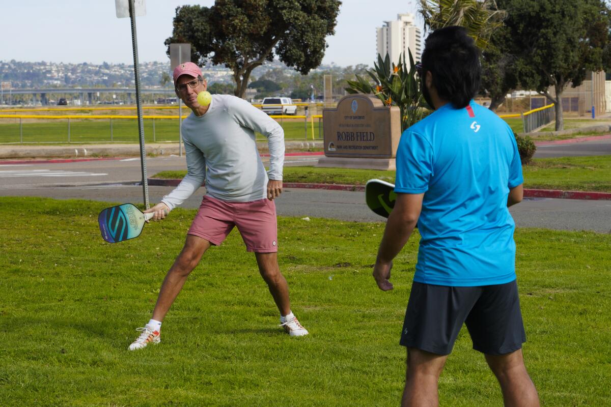 Stefan Boyland and Mike Shinzaki play some warmup pickleball in Ocean Beach. They want pickleball courts in Robb Field.