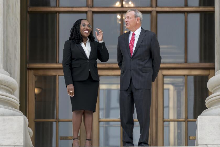 Justice Ketanji Brown Jackson, left, and Chief Justice John Roberts after her formal investiture ceremony on Sept. 30