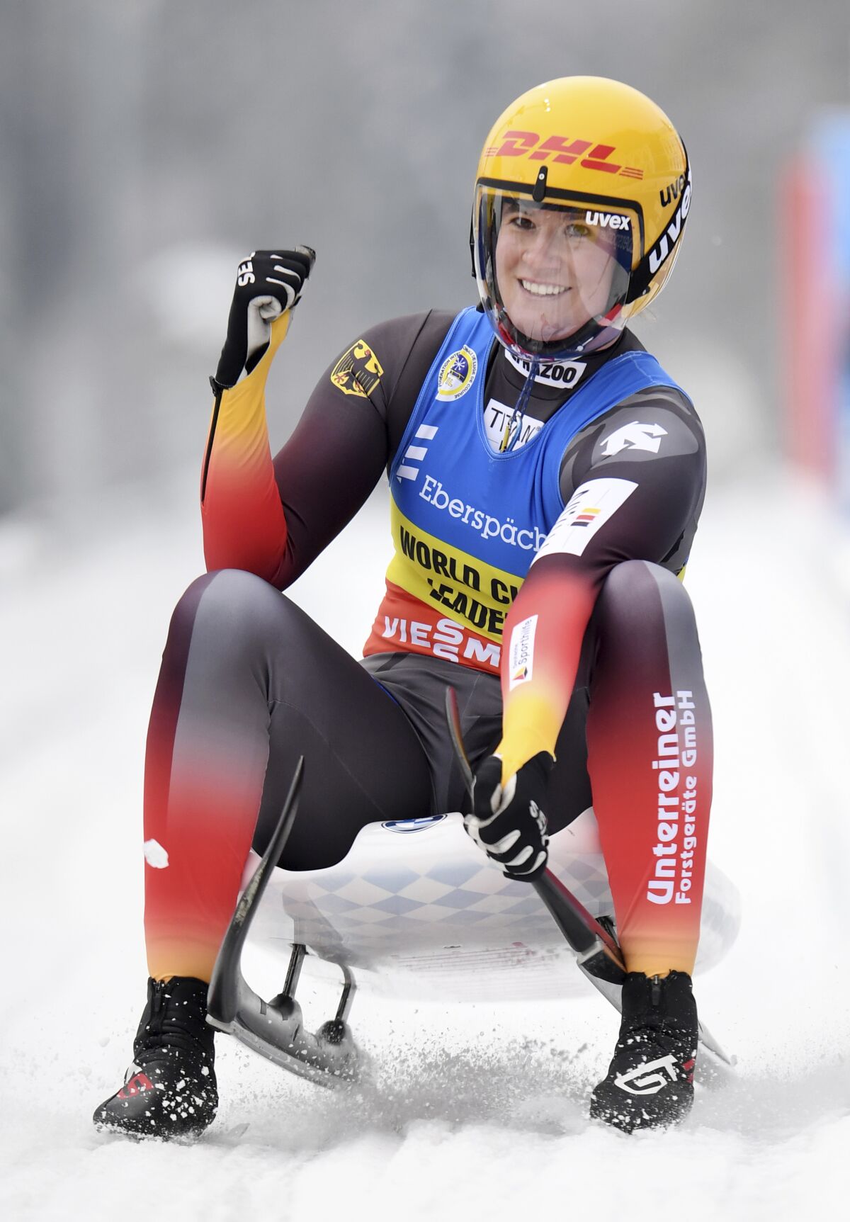 Second placed Natalie Geisenberger from Germany celebrates as she crosses the finish line for the women's single luge world cup race in Schoenau at the Koenigssee, Germany, Sunday, Jan. 3, 2021. (Tobias Hase/dpa via AP)