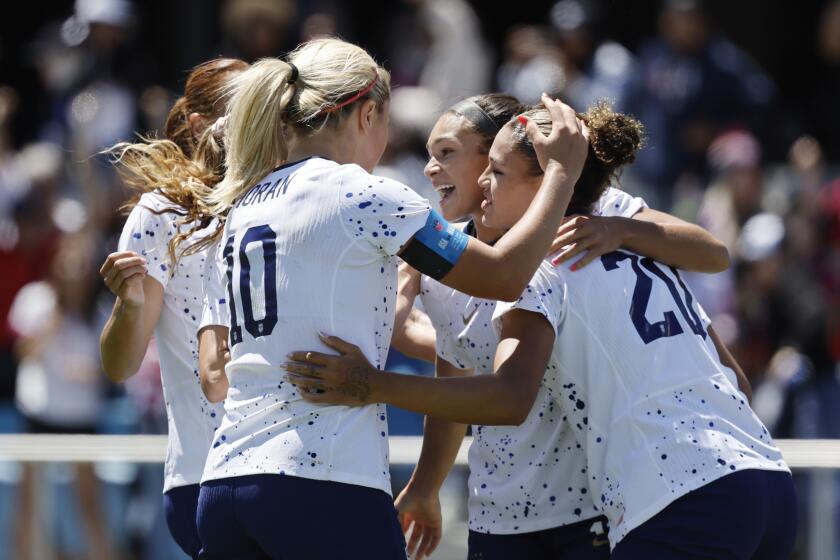 United States midfielder Lindsey Horan, left, and Sophia Smith, center, celebrate with forward Trinity Rodman, right, who scored in the second half of a FIFA Women's World Cup send-off soccer match against Wales in San Jose, Calif., Sunday, July 9, 2023. (AP Photo/Josie Lepe)
