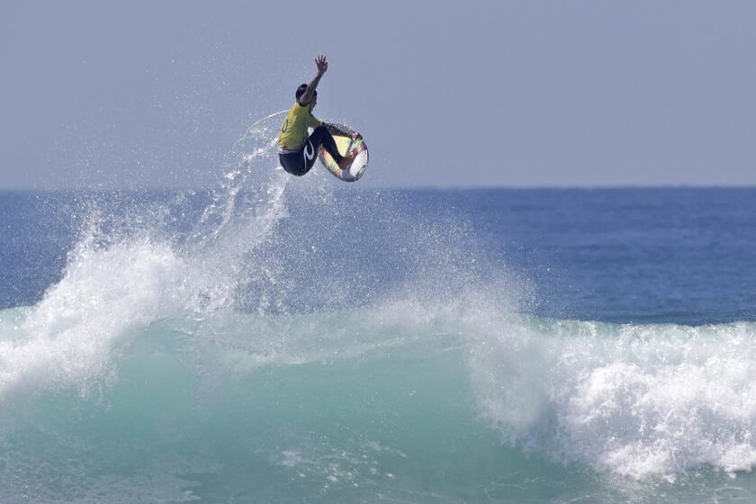 Three-time champion Gabriel Medina boosts a huge air and completes the ride during final against Felipe Toledo in the WSL Finals against Felipe Toledo at Trestles beach in San Clemente on Tuesday.