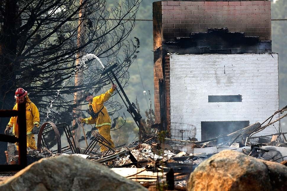 Firefighters respond to a burned structure at a church campground located on top of Apple Canyon Road in Mountain Center.