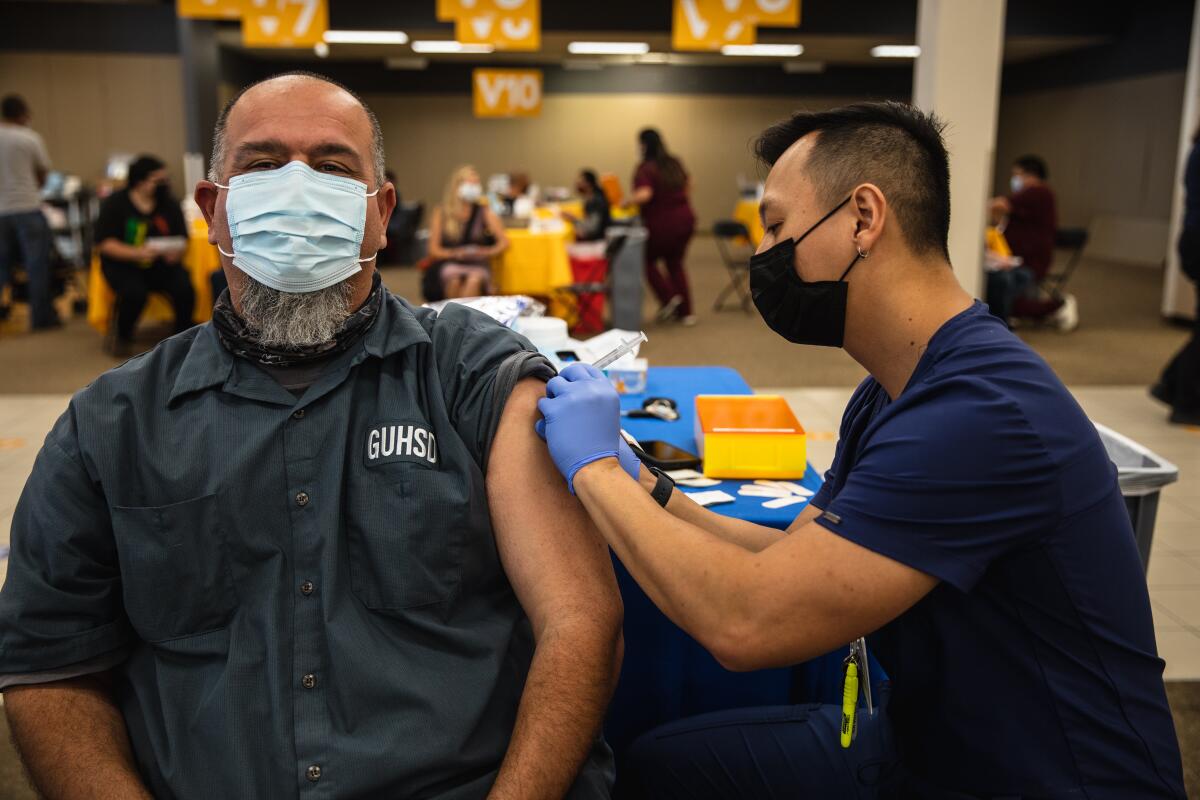 Roman Villa receives a Moderna vaccine from RN Andy Nguyen at Chula Vista Center  March 29.