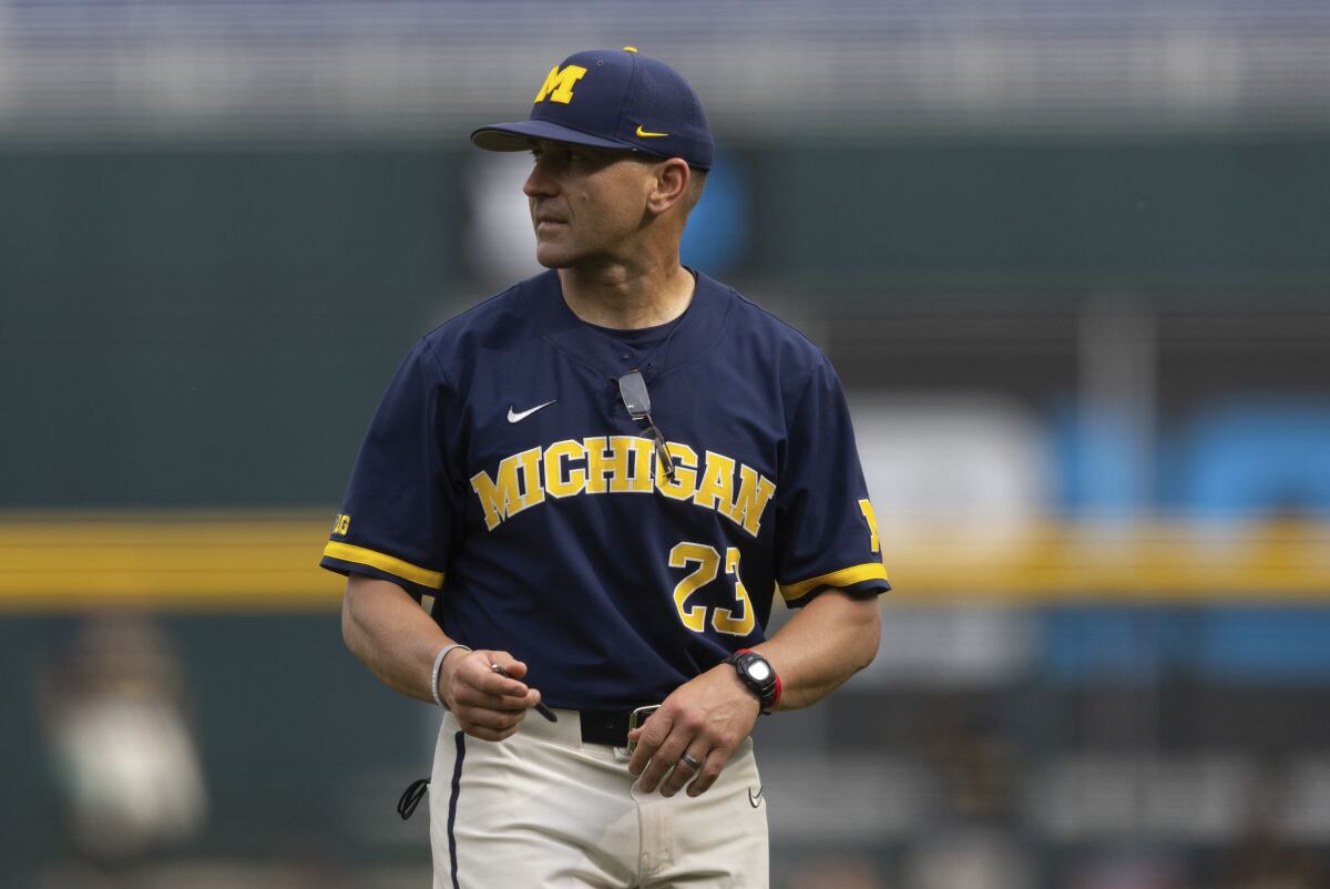 Michigan head coach Erik Bakich returns to the dugout after arguing with the umpires following a play at first base against Rutgers in the first inning of the NCAA college Big Ten baseball championship game Sunday, May 29, 2022, at Charles Schwab Field in Omaha, Neb. (AP Photo/Rebecca S. Gratz)