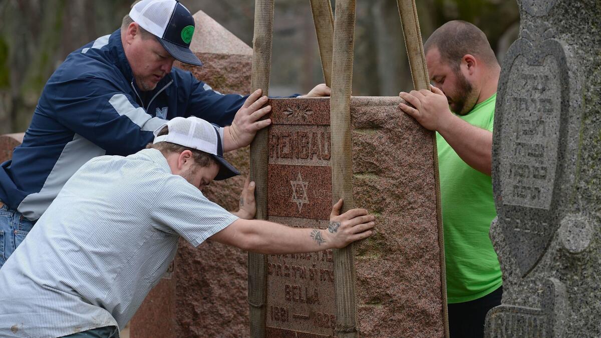 UNIVERSITY CITY, MO - FEBRUARY 22: Volunteers from a local monument company help to reset vandalized headstones at Chesed Shel Emeth Cemetery on February 22, 2017 in University City, Missouri. Since the beginning of the year, there has been a nationwide spike in incidents including bomb threats at Jewish community centers and reports of anti-semitic graffiti. (Photo: Michael Thomas/ Getty Images) ** OUTS - ELSENT, FPG, CM - OUTS * NM, PH, VA if sourced by CT, LA or MoD **