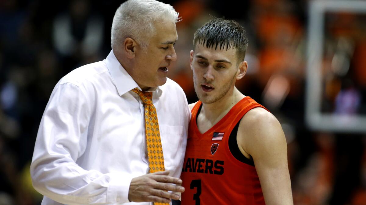 Oregon State coach Wayne Tinkle talks with his son Tres Tinkle on the sideline during the Beavers' game against Oregon in Corvallis on Jan. 5.