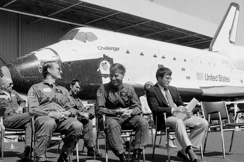 FILE - In this June 30, 1982, file photo, the new space shuttle Challenger sits behind the four astronauts that will fly it during turnover ceremonies at Rockwell International's final assembly site in Palmdale, Calif. From left: Dr. Story Musgrave, pilot Karol J. Bobko, mission specialist Donald H. Peterso, and commander Paul J. Weitz. Weitz, a retired NASA astronaut who commanded the first flight of the space shuttle Challenger and flew on Skylab in the early 1970s, has died at 85. Weitz died at his retirement home in Flagstaff, Ariz., on Monday, Oct. 23, 2017, said Laura Cutchens of the Astronaut Scholarship Foundation. (AP Photo/Doug Pizac, File)