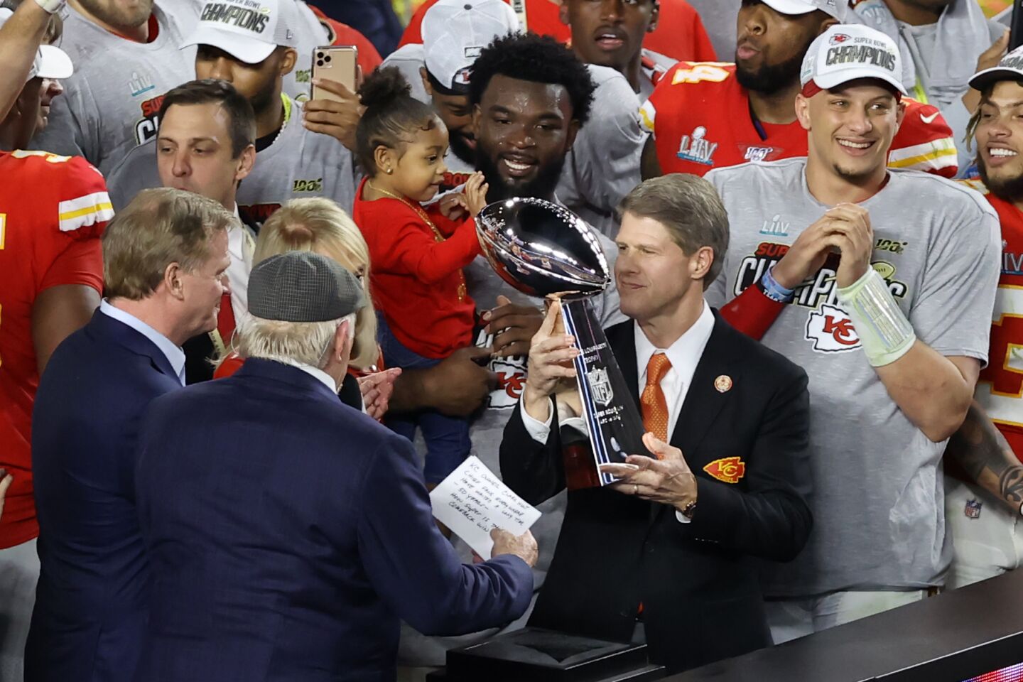 Kansas City Chiefs owner Clark Hunt holds the Vince Lombardi Trophy after the team's victory over the San Francisco 49ers in Super Bowl LIV.