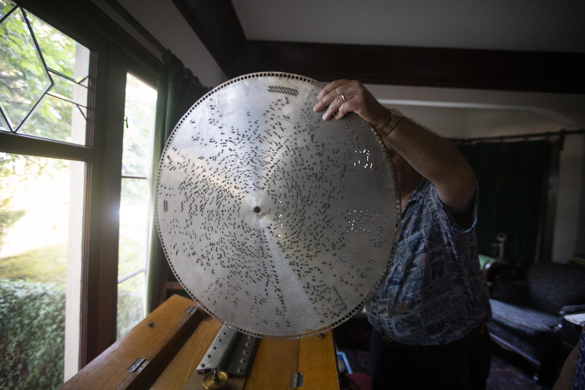 Michael Khanchalian with a Regina music box disc dating from 1896.