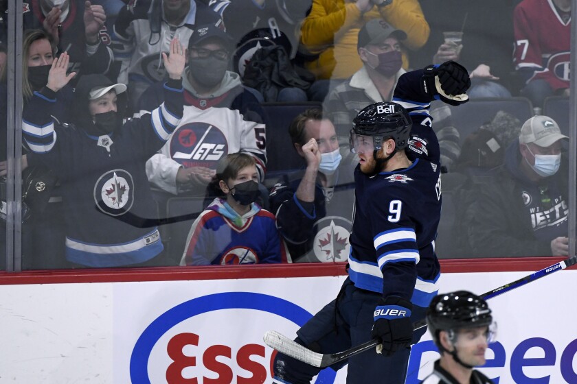 Winnipeg Jets' Andrew Copp (9) celebrates his goal against the Montreal Canadiens during the second period of an NHL hockey game Tuesday, March 1, 2022, in Winnipeg, Manitoba. (Fred Greenslade/The Canadian Press via AP)