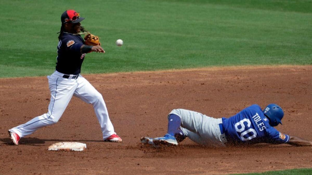 After forcing out the Dodgers' Andre Toles at second, the Indians' Michael Martinez throws to first base to complete a double play during Monday's game.