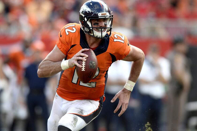 Broncos reserve quarterback Paxton Lynch scrambles away from pressure against the Buccaneers on Sunday.