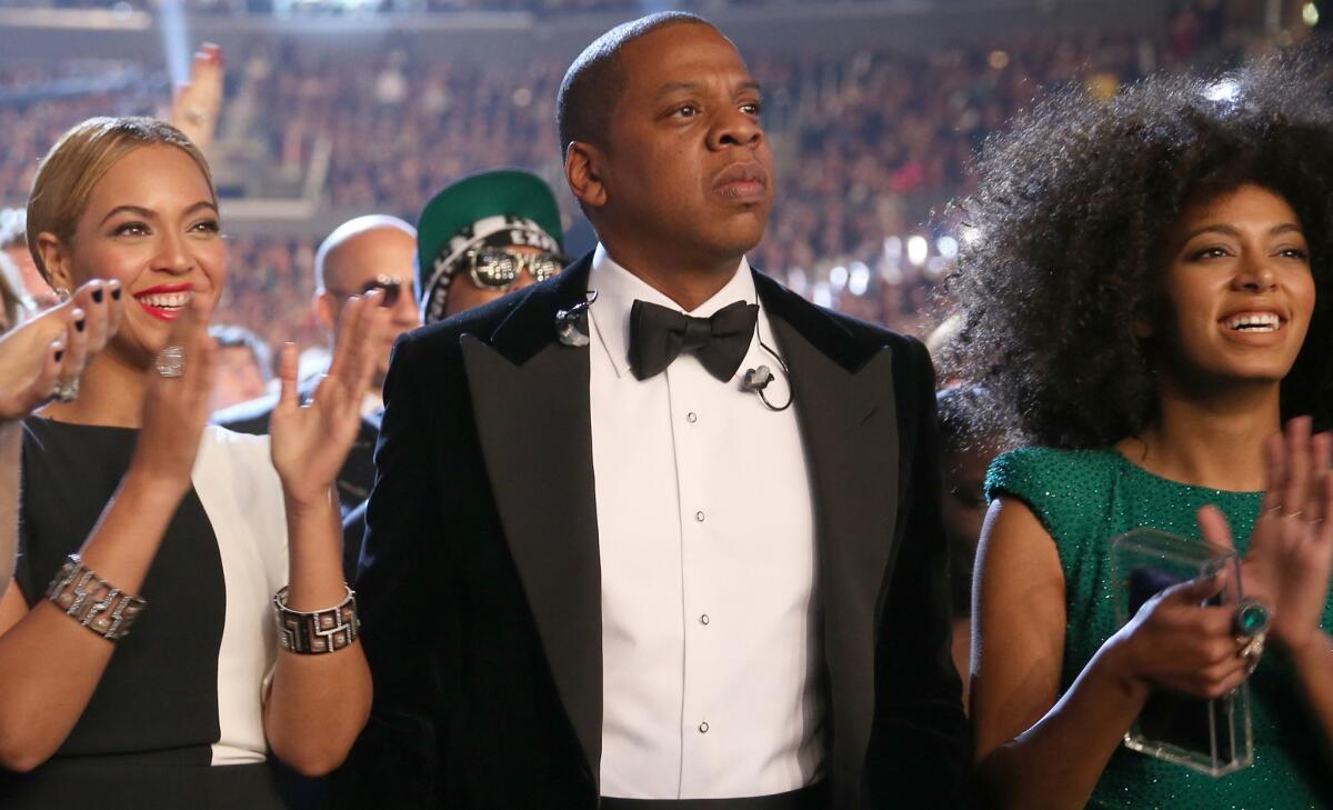 Beyonce, left, Jay Z and Solange Knowles say they've kissed and made up after a May 5 fight captured on surveillance video. The scene in the elevator went public Monday.