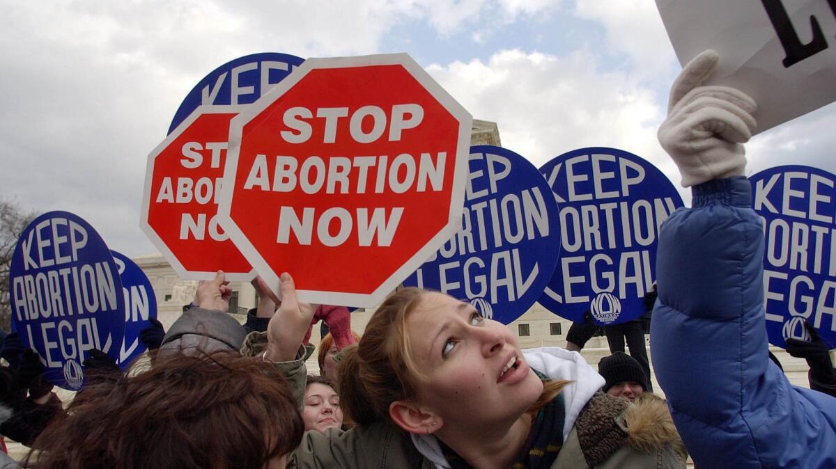 Pro-life demonstrators stand in front of pro-choice counter-demonstrators in front of the U.S. Supreme Court on Jan. 22, 2004.