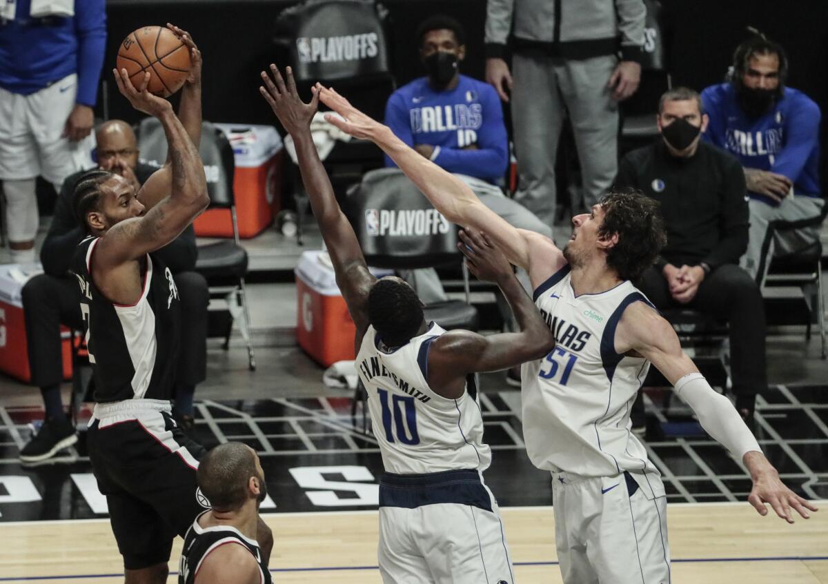 Clippers forward Kawhi Leonard shoots over Mavericks forward Dorian Finney-Smith and center Boban Marjanovic during Game 5.