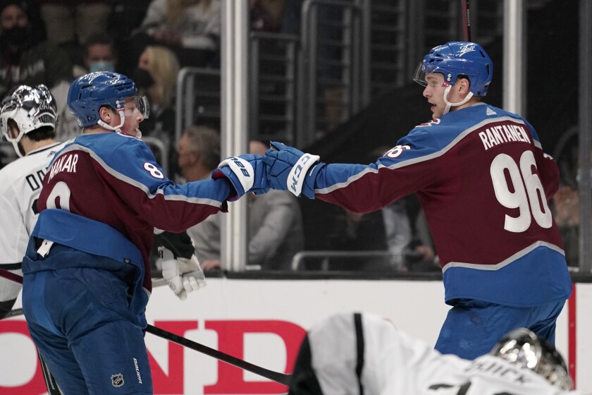 Colorado Avalanche right wing Mikko Rantanen, right, celebrates his goal with defenseman Cale Makar during the first period of an NHL hockey game Thursday, Jan. 20, 2022, in Los Angeles. (AP Photo/Mark J. Terrill)