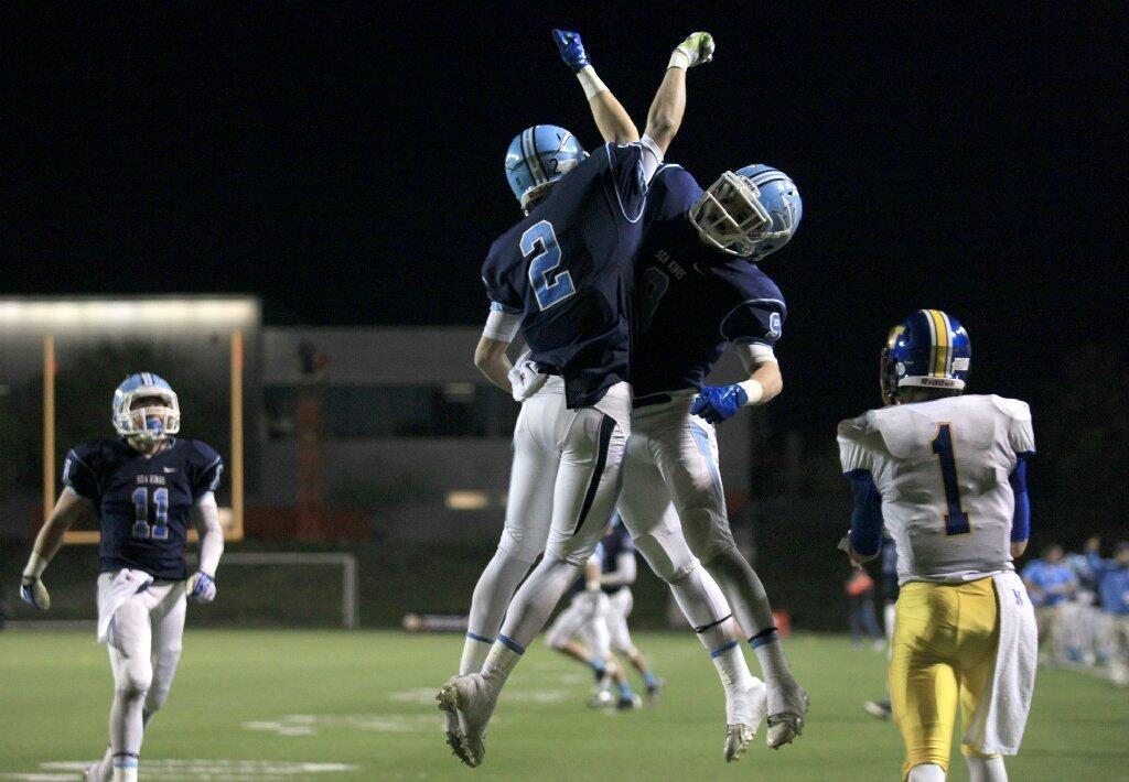 Corona del Mar High's Bo St. Geme (2) celebrates, after scoring a touchdown, with teammate Cole Collins, right, during the third quarter against Nordhoff in the CIF State Southern California Regional Division III Bowl Game at LeBard Stadium in Costa Mesa on Saturday.