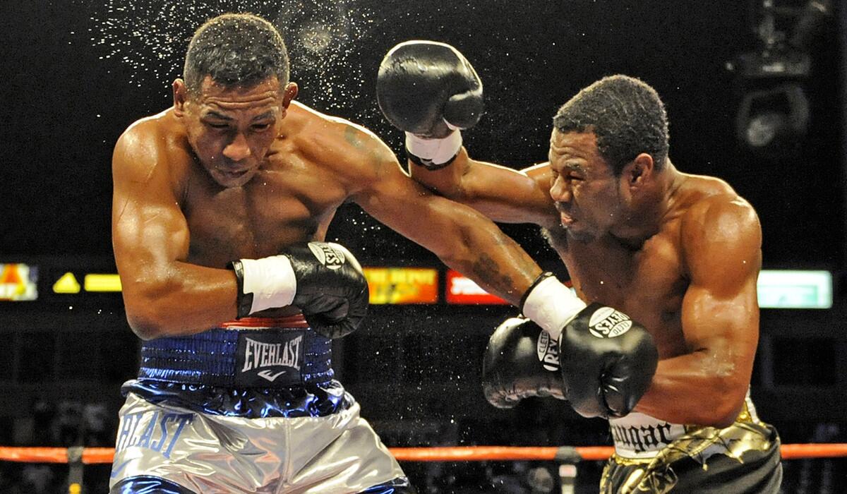 Shane Mosley, right, knocks the sweat out of Ricardo Mayorga at Home Depot Center in Carson on Sept. 27, 2008.