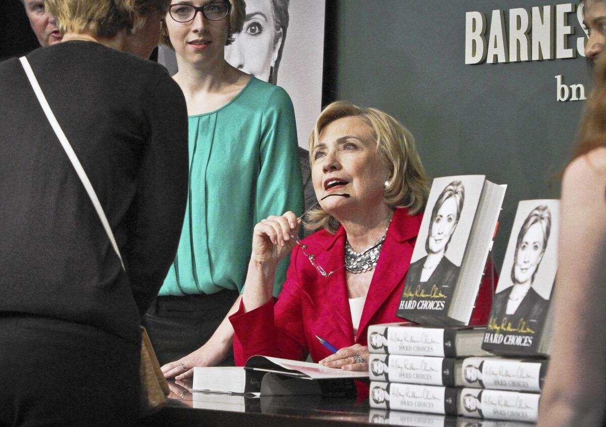 Hillary Rodham Clinton signs copies of her new memoir at a bookstore in New York. Some people waited in line overnight in hopes of having their copies signed.