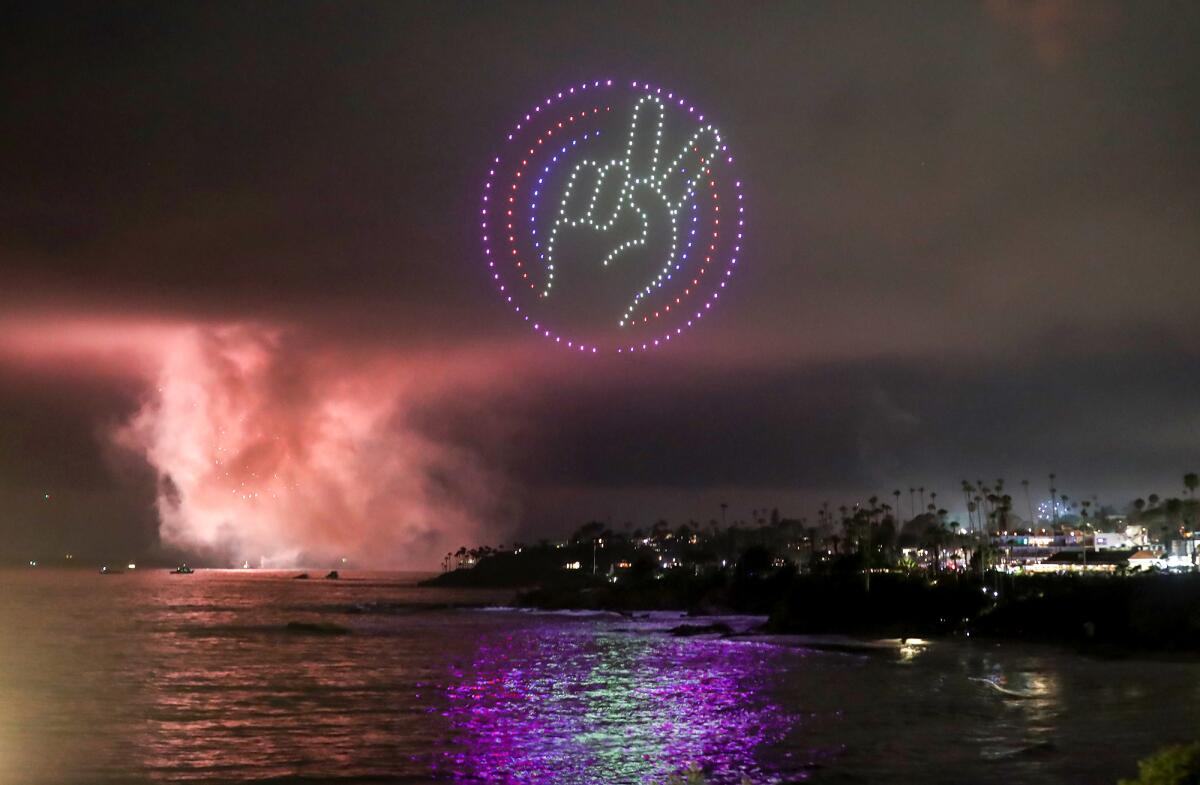 Drones form a peace sign as part of the Fourth of July drone show over Main Beach Park.