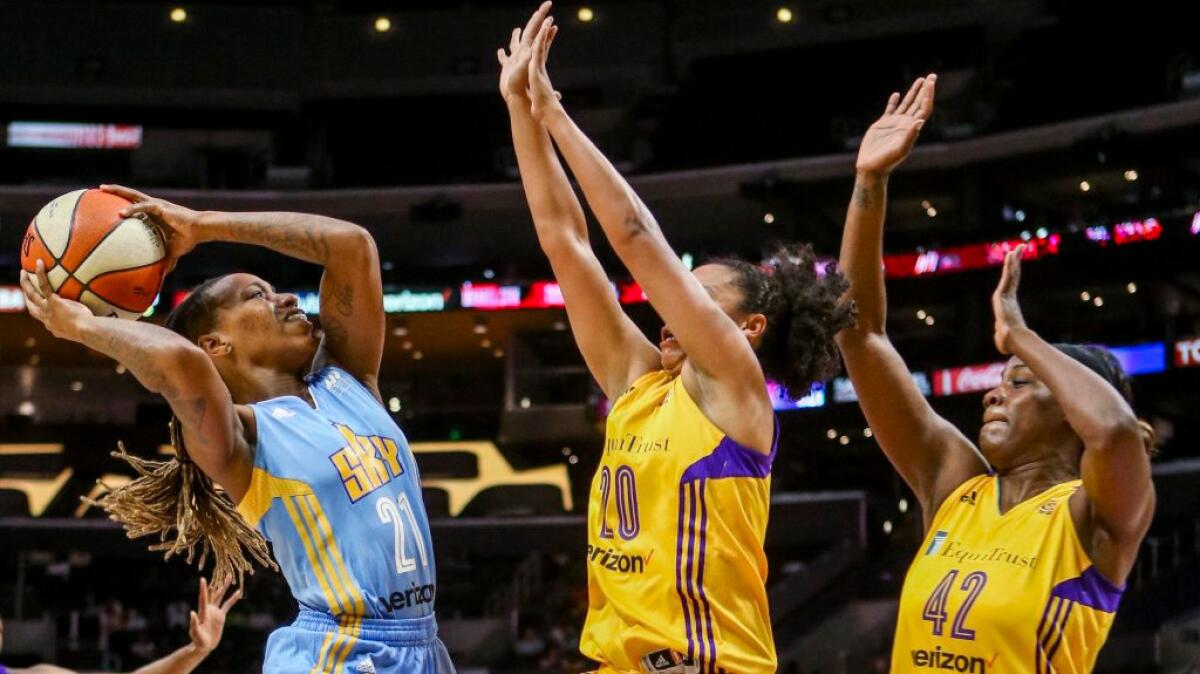 Sky guard Jamierra Faulkner goes up for a shot under pressure from Sparks guard Kristi Toliver and center Jantel Lavender, right, during the first half of Game 2 of a semifinal playoff game on Sept. 30.