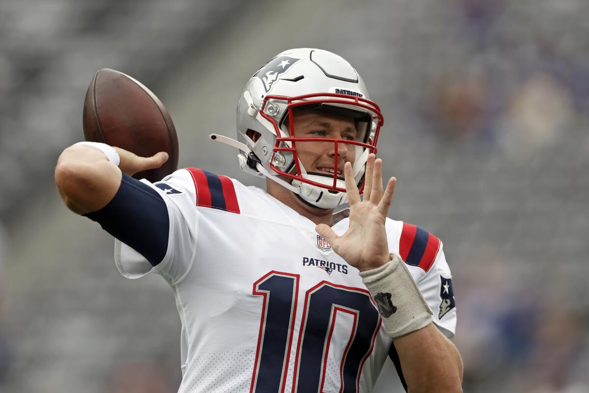 New England Patriots quarterback Mac Jones warms up before a game against the New York Giants on Aug. 29.