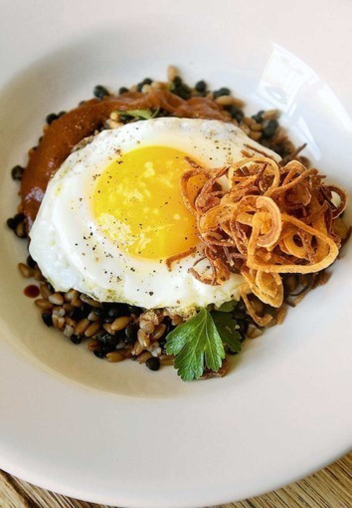 Farro and lentils with fried shallots, harissa and a fried egg are served for brunch at Cortez in Los Angeles.