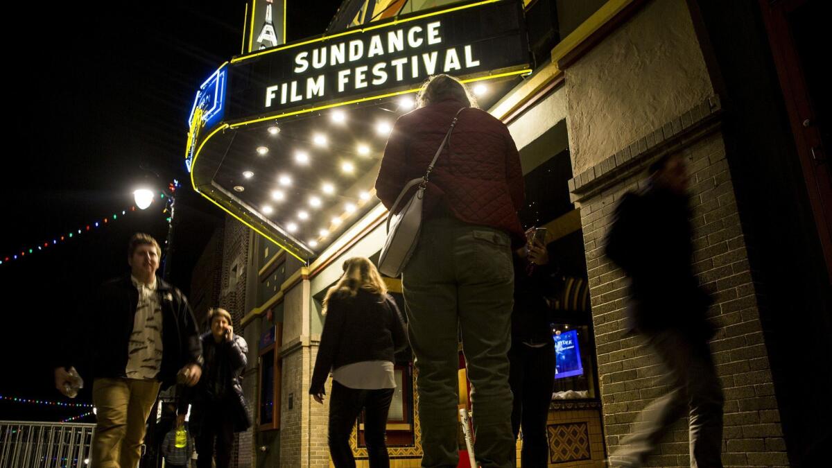 People walk past the Egyptian Theatre in Park City, Utah, during the 2018 Sundance Film Festival.