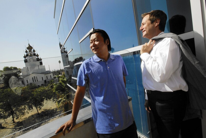 Jason Zhu of Gemdale USA and Charles Tourtellotte of LaTerra survey the neighborhood from the balcony of the site in Hollywood near Sunset and Western where they will combine forces to build a $125-million mixed-use housing project.