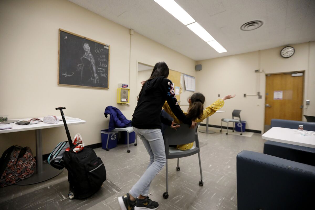 Shanti Raminani and her friend Mia Turel take a moment to be playful on campus. The pair are very serious about their academics, but there is a strong social component to the Cal State L.A. program. (Francine Orr / Los Angeles Times)