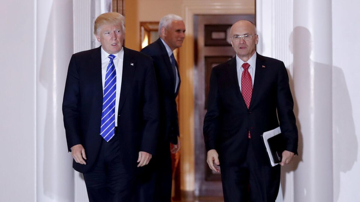 President-elect Donald Trump and Andy Puzder, nominee for secretary of Labor, leave the clubhouse of a Trump golf course in New Jersey.