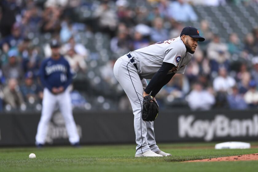 Detroit Tigers starting pitcher Eduardo Rodriguez reacts after dropping the ball, allowing Seattle Mariners' Jarred Kelenic to reach first base on the error during the second inning of the first game of a baseball doubleheader, Tuesday, Oct. 4, 2022, in Seattle. (AP Photo/Caean Couto)