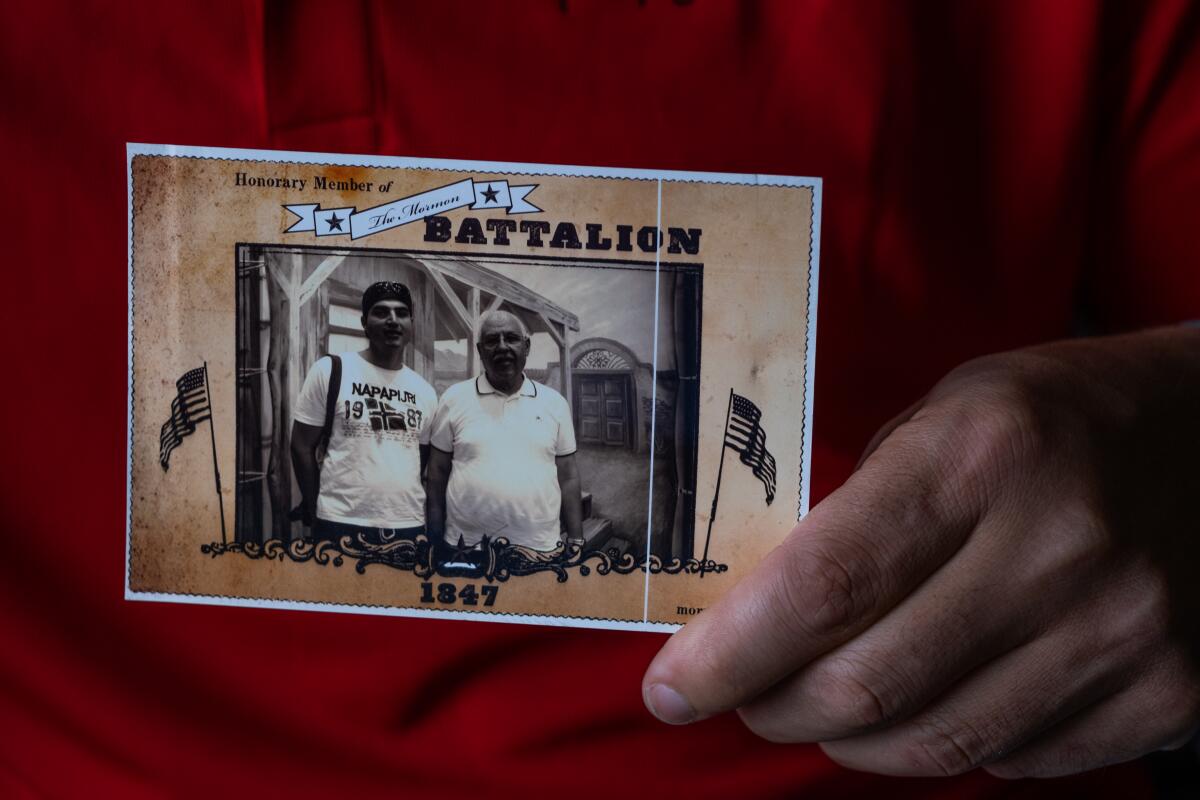 Loay Elbasyouni holds a photograph of him with his father. 