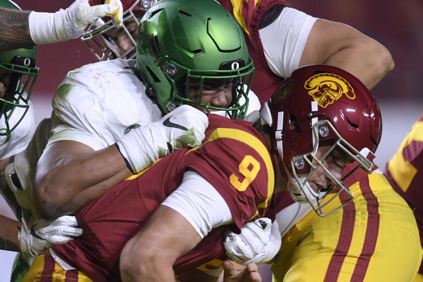 USC's Kedon Slovis is sacked by Oregon's Brandon Dorlus during the Pac-12 title game Dec. 18, 2020, in Los Angeles.