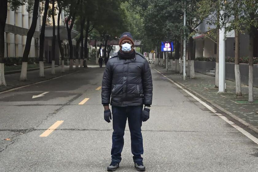 This Jan. 27, 2020, photo, provided by Dr. Khamis Hassan Bakari of Tanzania, shows him posing for a photo in Wuhan, China. Bakari is among more than 4,000 African students in the Chinese city of 11 million people, and has been sending updates on social media about the outbreak of a new virus to the more than 400 other Tanzanian students in Wuhan, as China’s astonishing lockdown of more than 30 million people continues. (Khamis Hassan Bakari via AP)