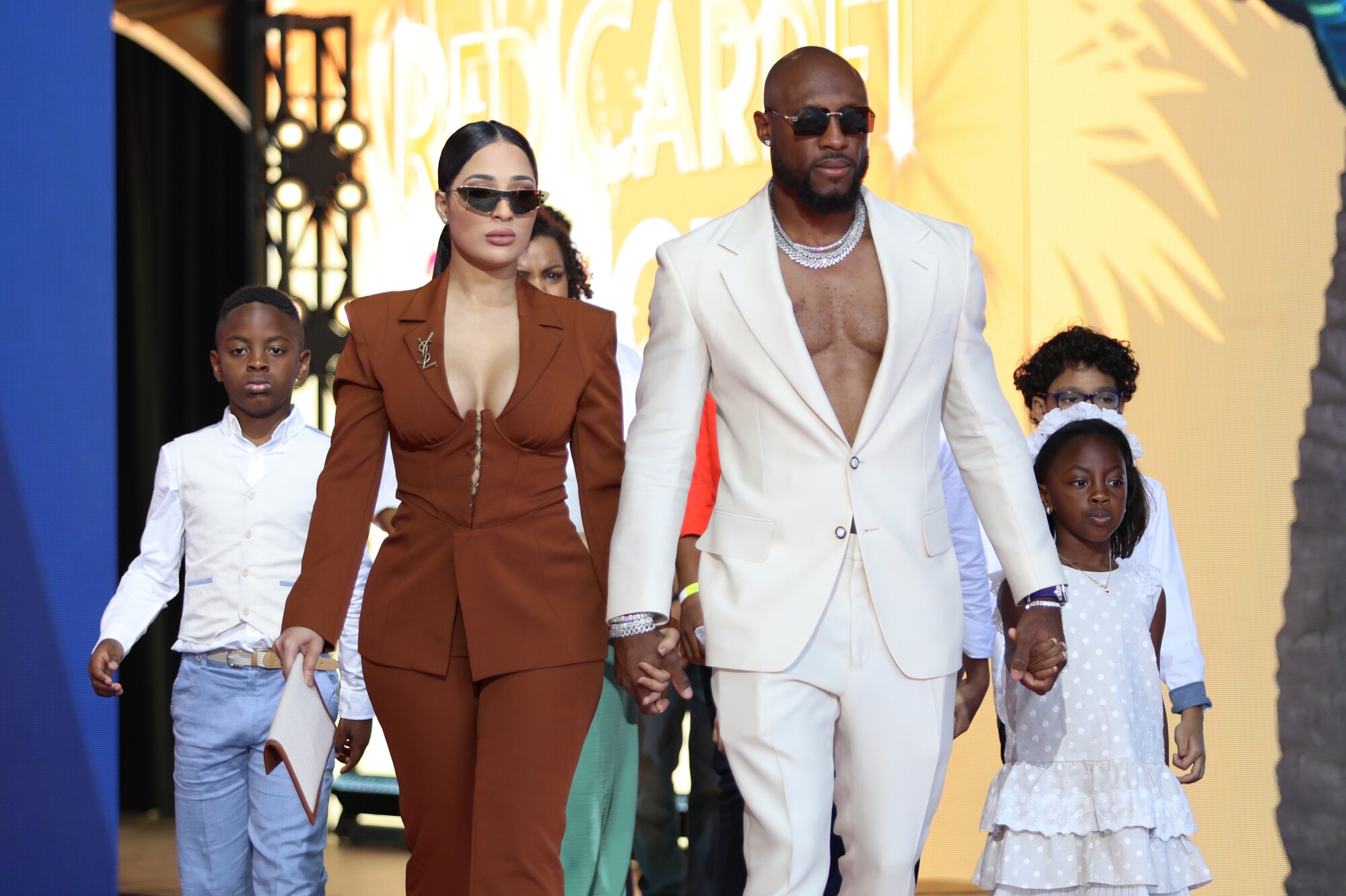 Starling Marte in a white suit and his family arrive at the 2022 MLB All-Star Game Red Carpet Show.