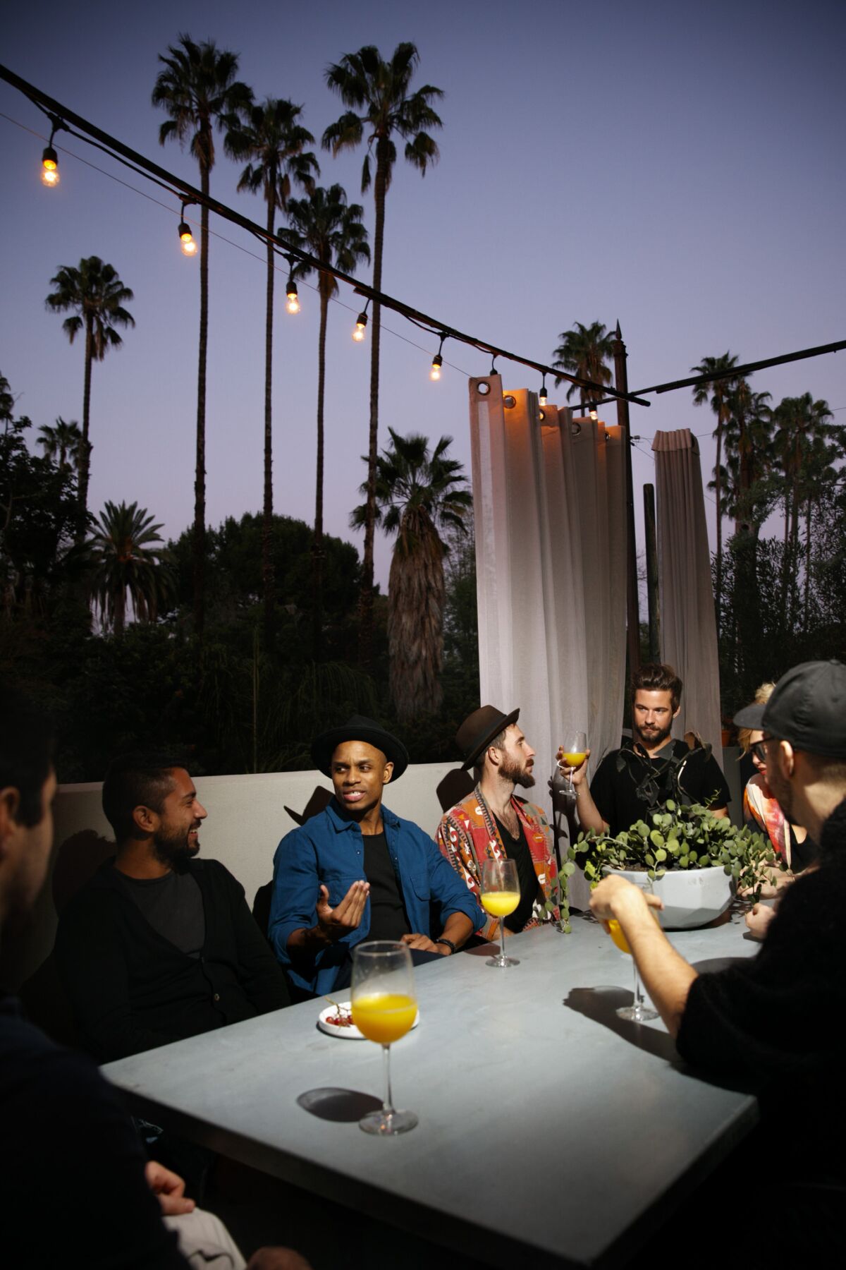 Matty Pipes and friends enjoy the outdoors beneath a simple string of lights in Hollywood.