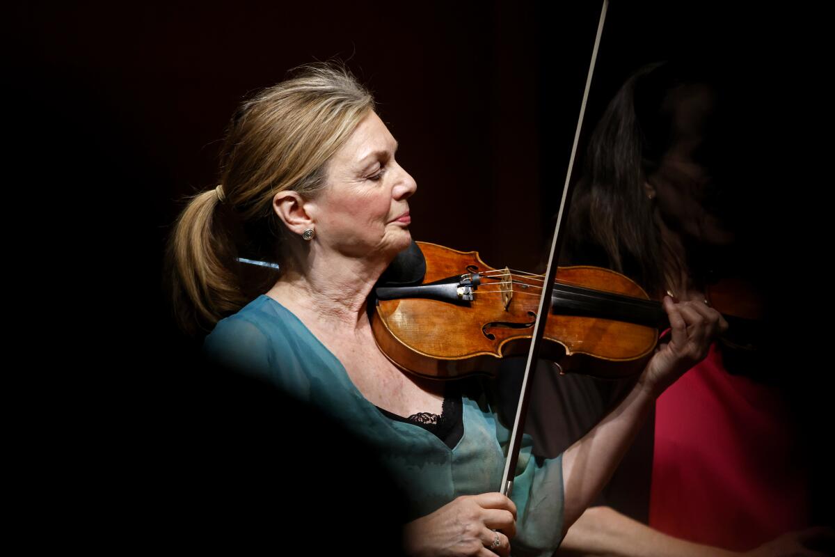 A woman playing the violin. 