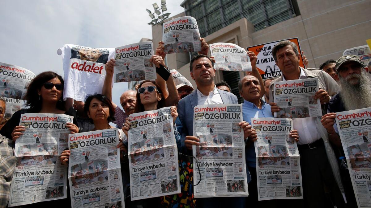Journalists and others gather outside a court in Istanbul on Friday to protest the trial of journalists from the Cumhuriyet newspaper.