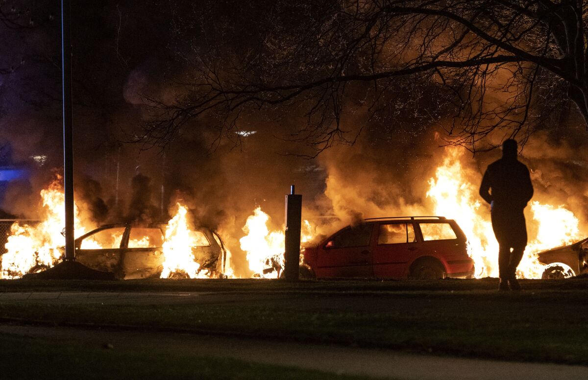 Cars are engulfed by flames after protests broke out at Rosengard in Malmo, Sweden, late Sunday, April 17, 2022. The riots broke out following Danish far-right politician Rasmus Paludan’s meetings and planned Quran burnings in various Swedish cities and towns since Thursday. (Johan Nilsson/TT via AP)