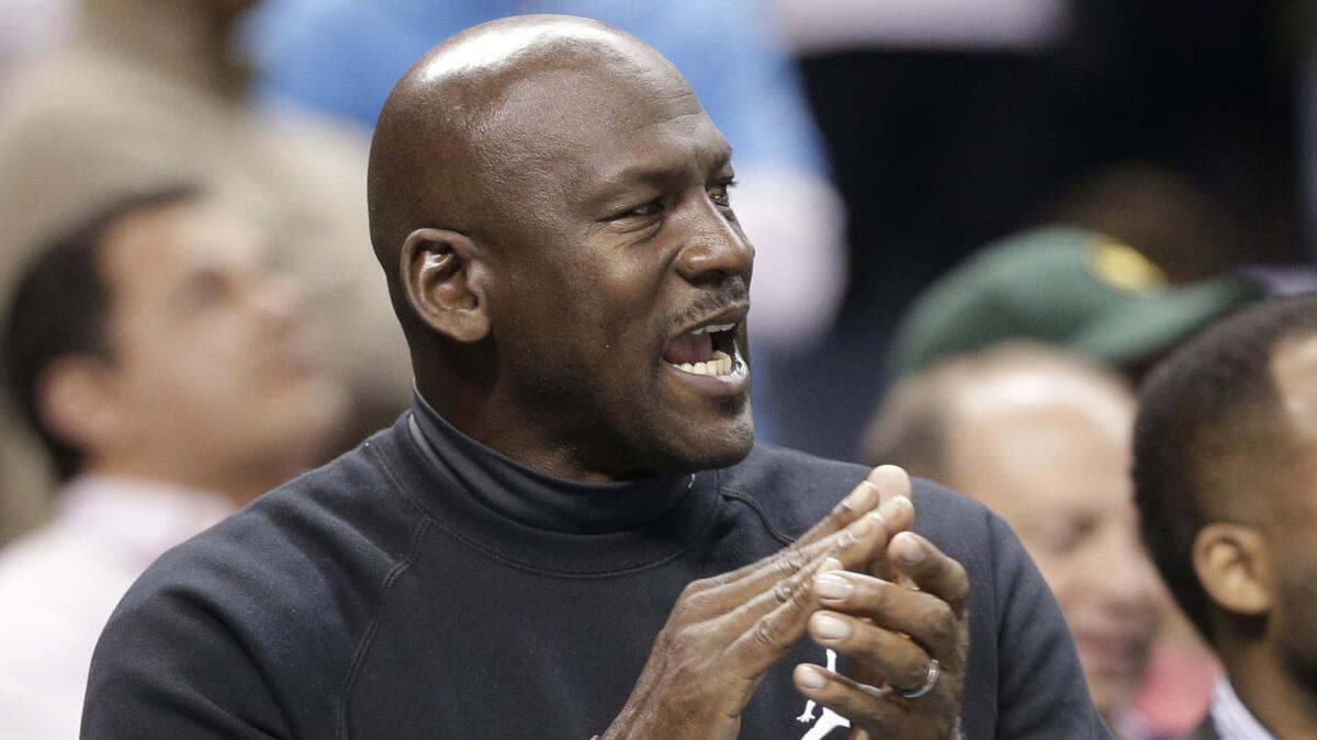 Charlotte Hornets owner Michael Jordan applauds during a game against the Washington Wizards on Feb. 5.