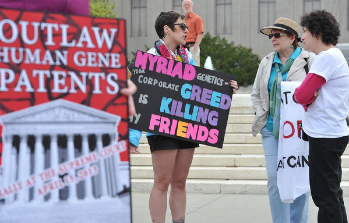 Protesters hold banners demanding a ban on human genes patents during a protest outside the Supreme Court in Washington in April.