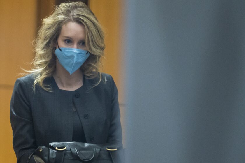 Elizabeth Holmes walks into federal court in San Jose, Calif., Monday, Jan. 3, 2022. (AP Photo/Nic Coury)