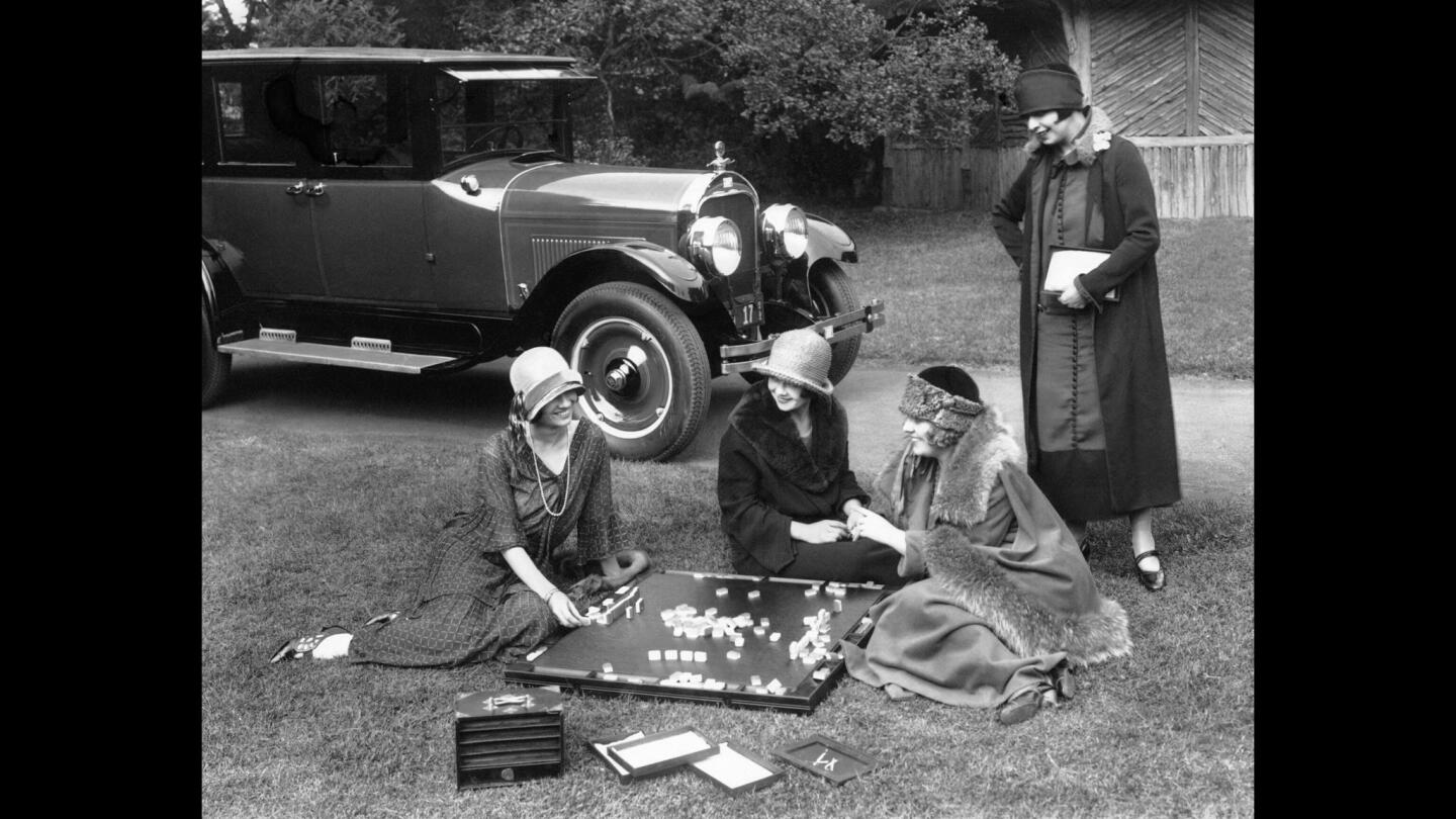 Women play mahjong on a California lawn.
