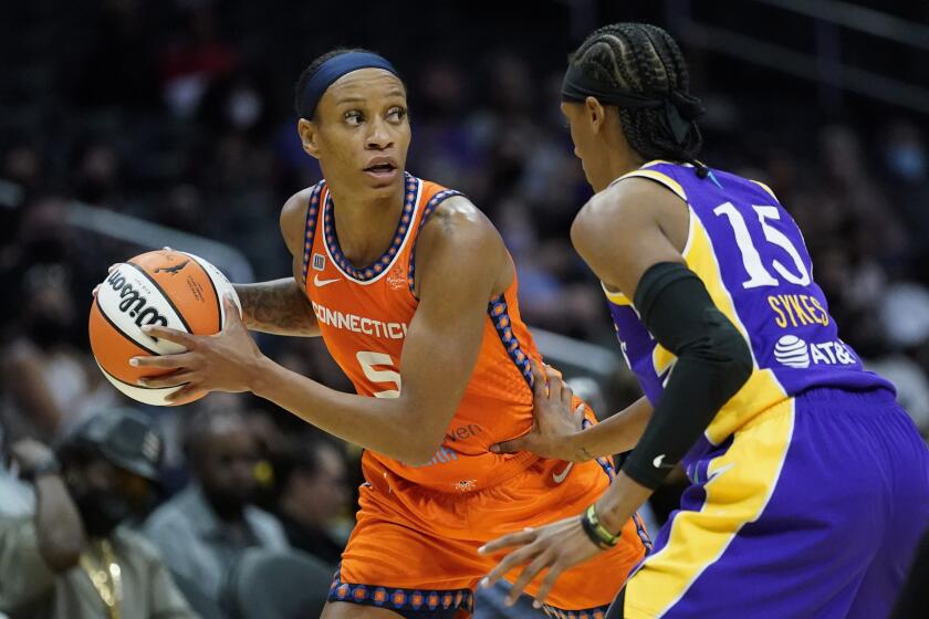 Los Angeles Sparks guard Brittney Sykes (15) defends against Connecticut Sun guard Jasmine Thomas (5) during the first half of WNBA basketball game Thursday, Sept. 9, 2021, in Los Angeles. (AP Photo/Ashley Landis)
