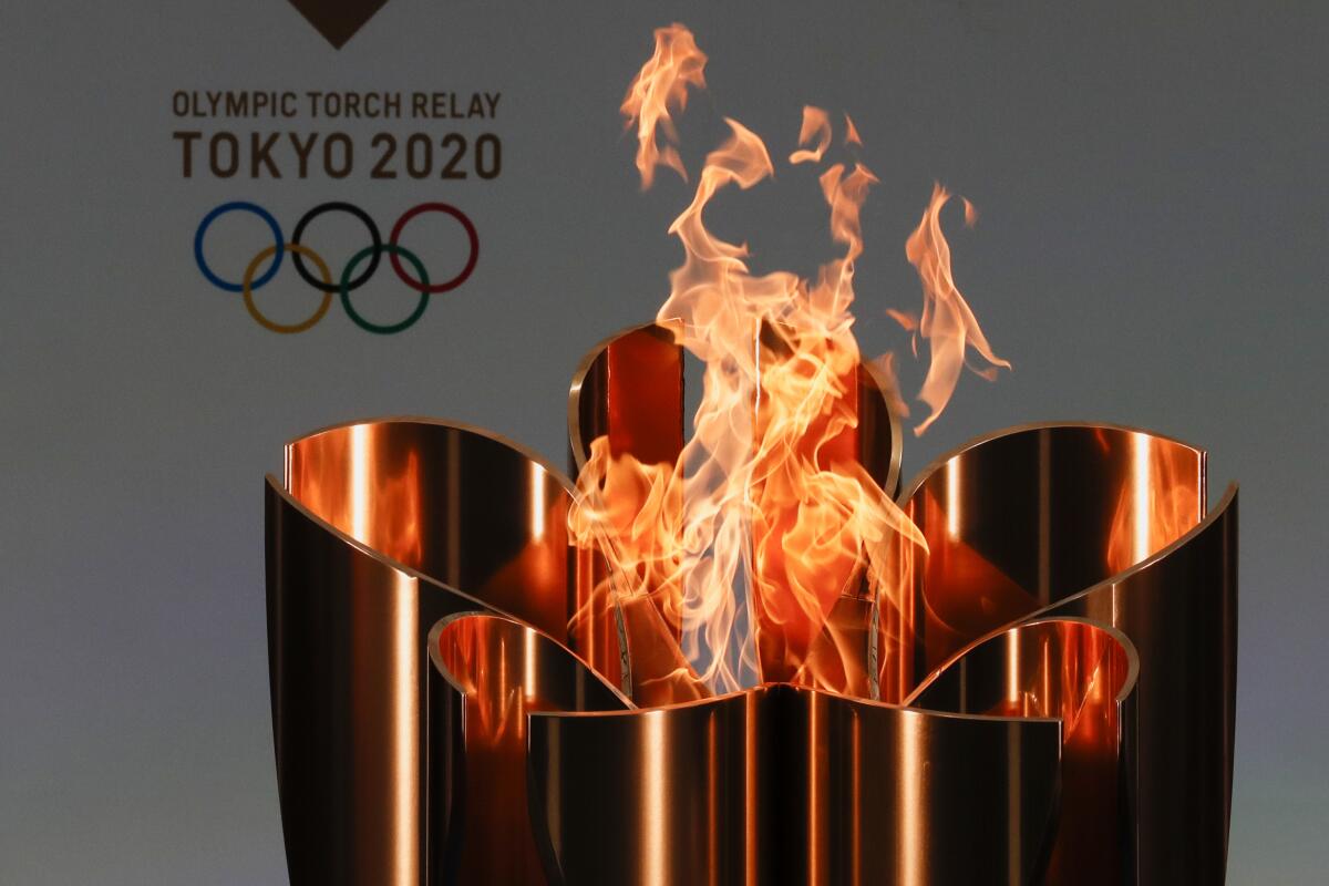 FILE - In this March 25, 2021, file photo, the celebration cauldron is seen lit on the first day of the Tokyo 2020 Olympic torch relay in Naraha, Fukushima prefecture, northeastern Japan. The Tokyo Olympics are not looking like much fun: Not for athletes. Not for fans. And not for the Japanese public, who are caught between concerns about the coronavirus at a time when few are vaccinated on one side and politicians and the International Olympic Committee who are pressing ahead on the other. (Kim Kyung-Hoon/Pool Photo via AP, File)