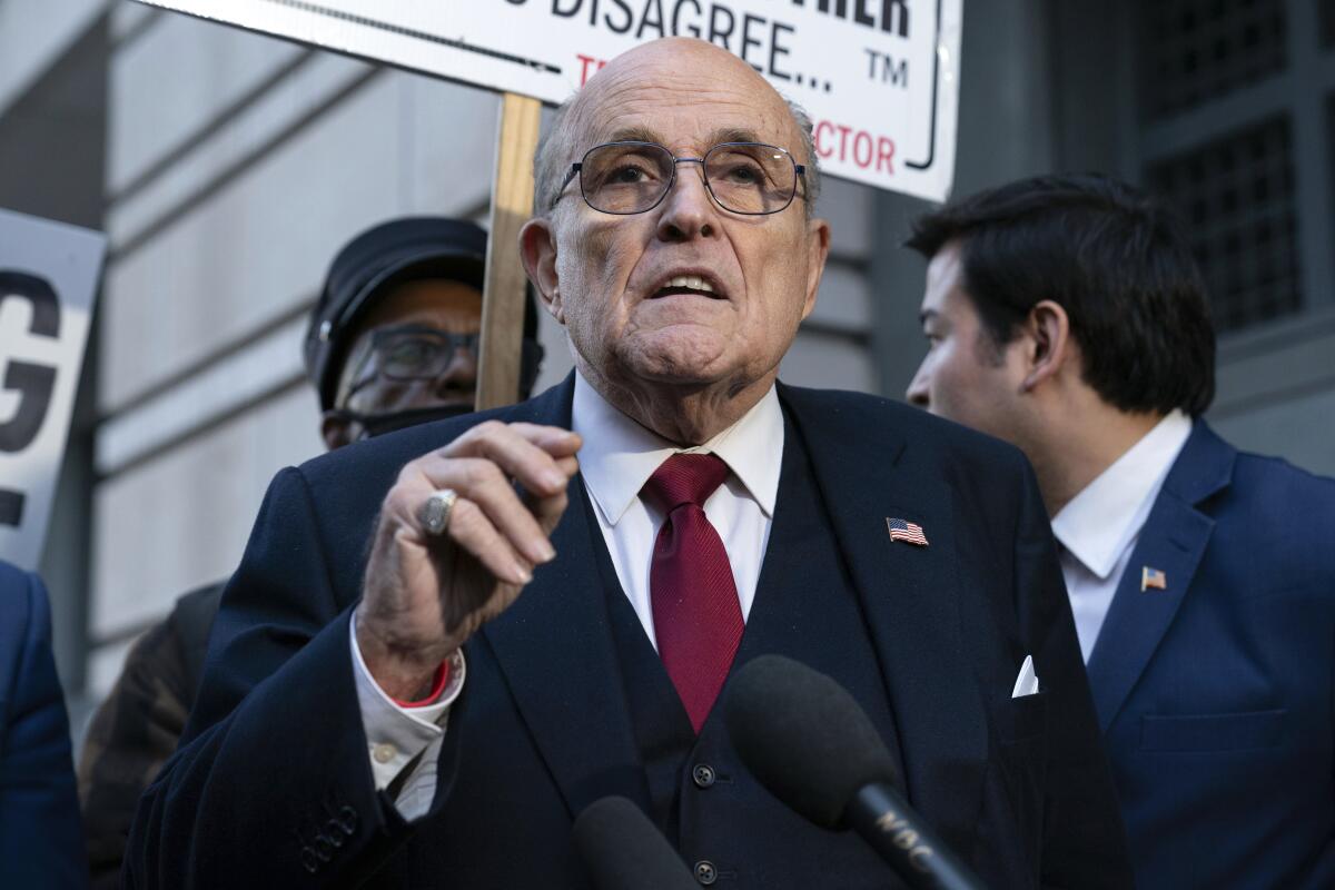 Former Mayor of New York Rudoph Giuliani speaks into a mic.
